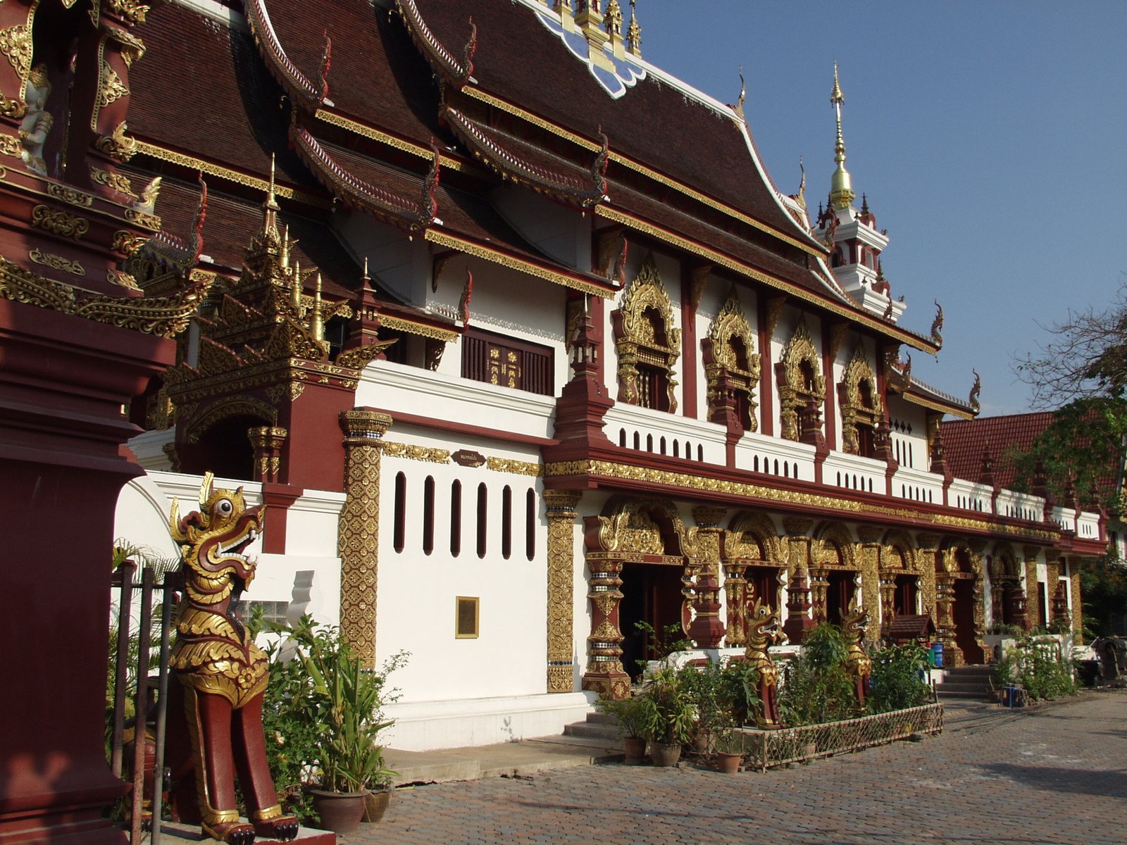 an elaborate building with a gold statue in front of it