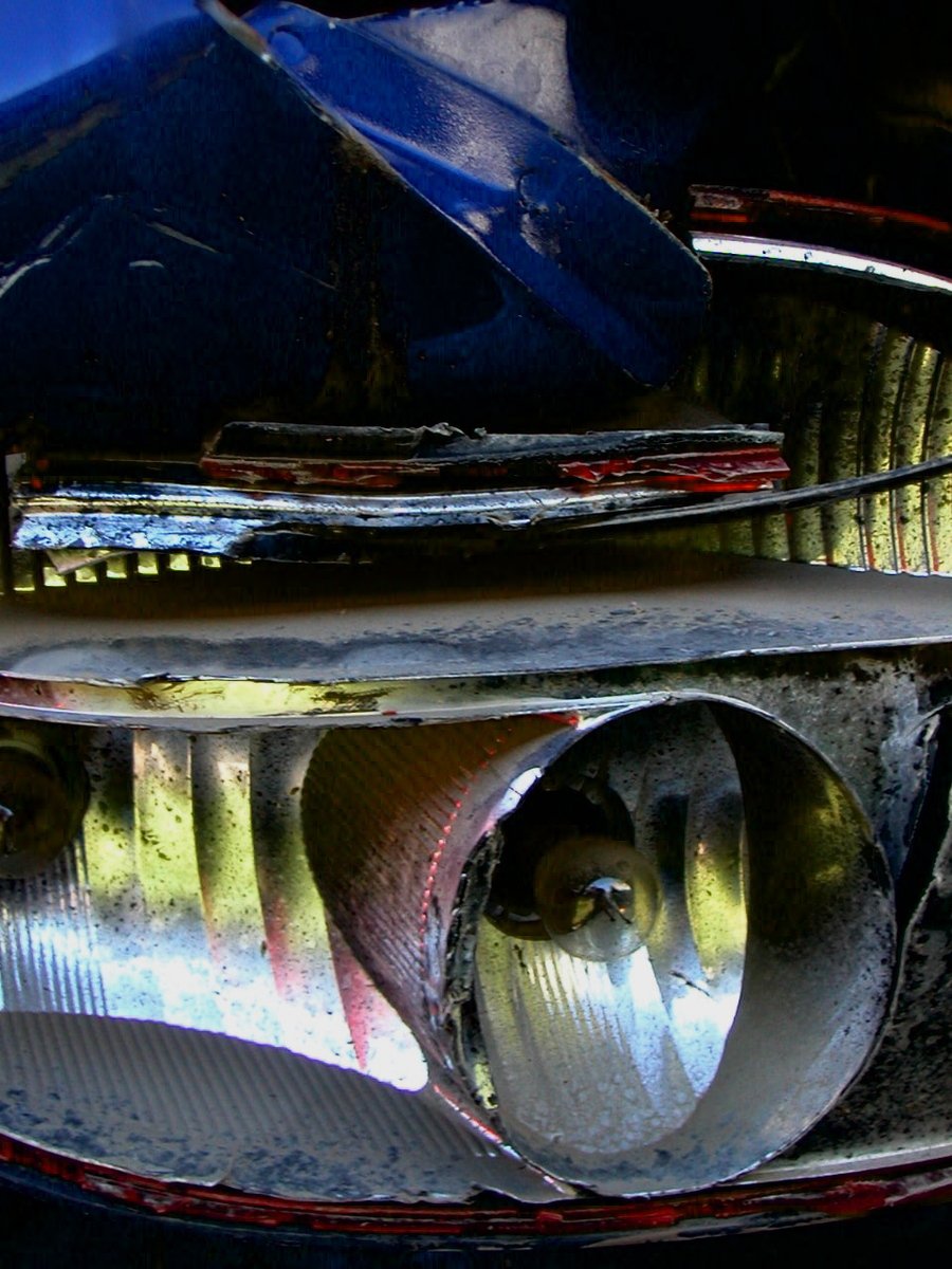 a closeup of the front hood of a car with hood rings and other parts on it