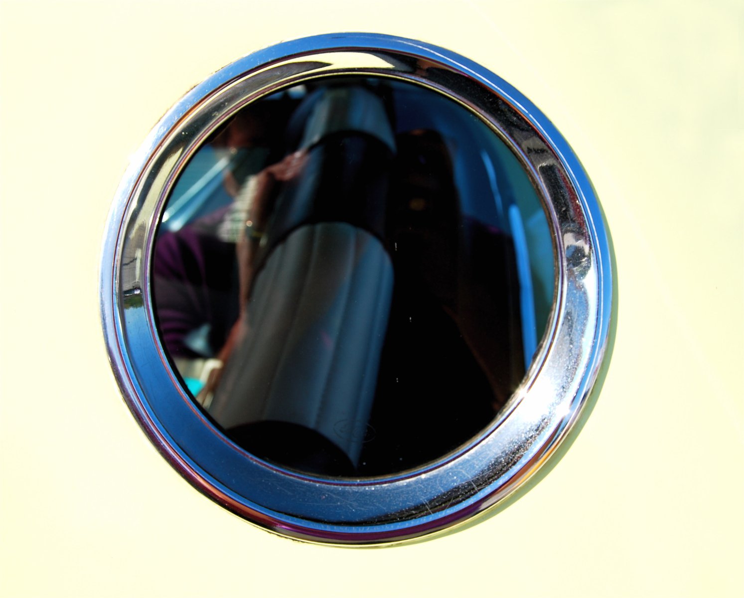 a mirror sitting on the side of a wall next to a floor