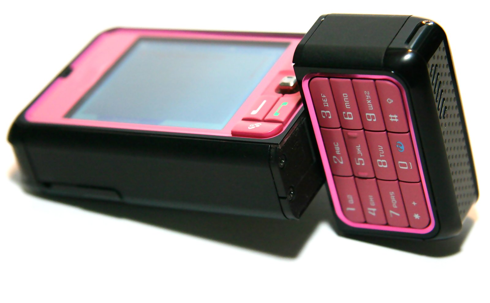 a colorful cell phone sitting next to a black smart phone