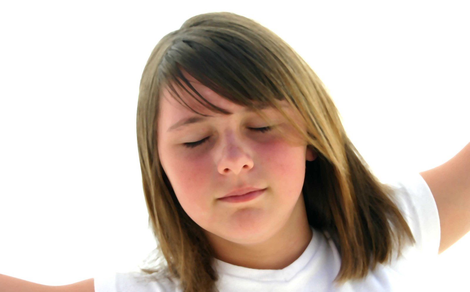 girl in white t - shirt blowing her hair by hand