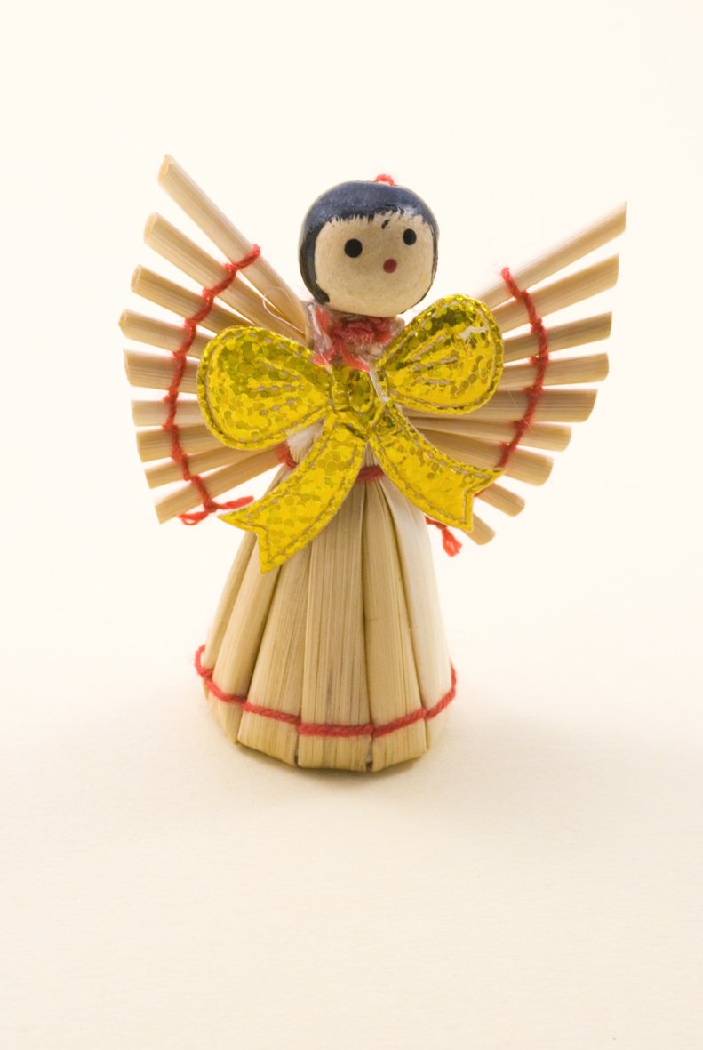 a small toy made from matches sticks and holding a doll