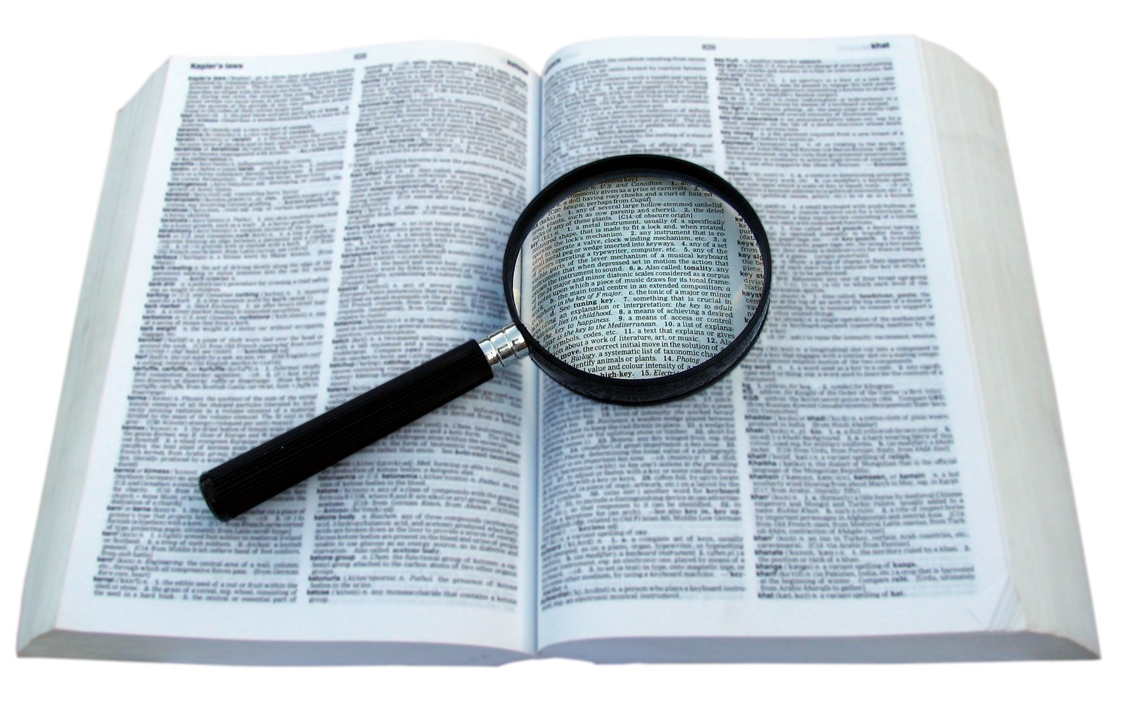 the magnifying glass is positioned above an open bible