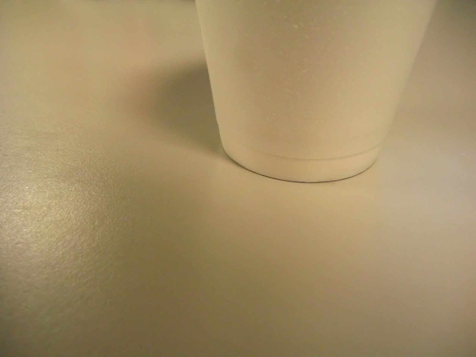 two white cup on table with silver colored trim