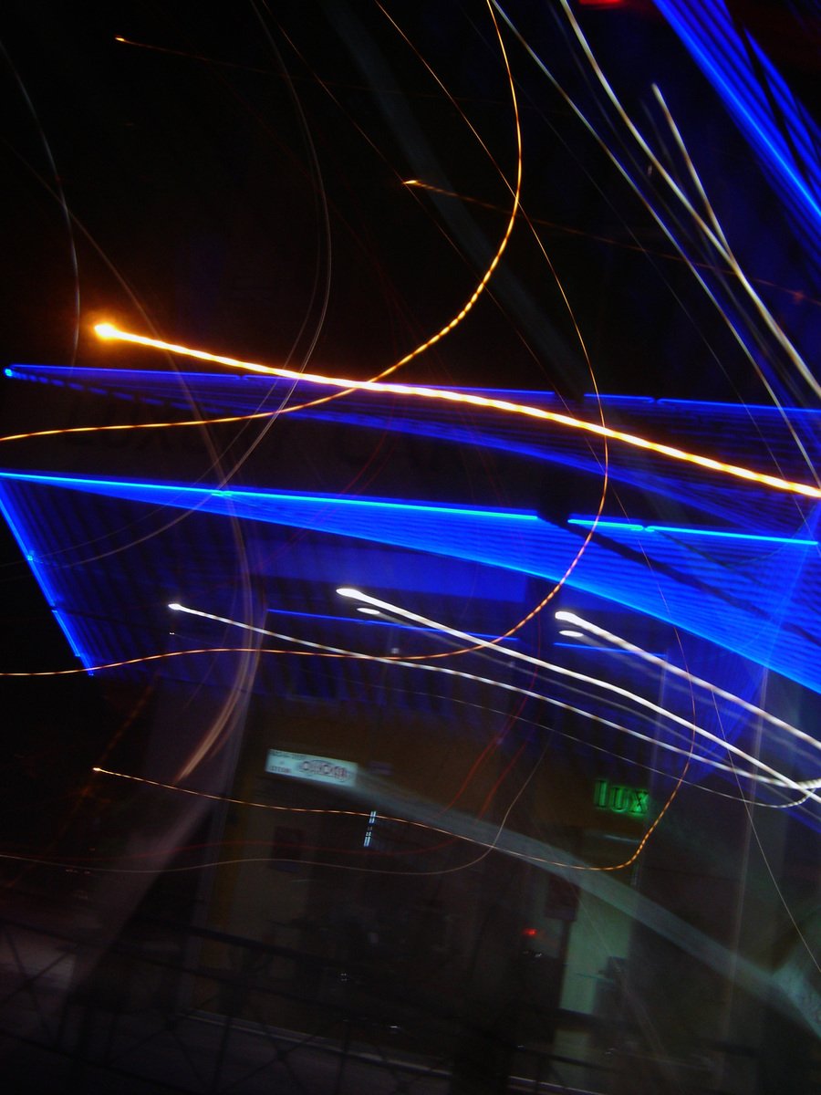 night sky light painting of colorful motion blur on a street