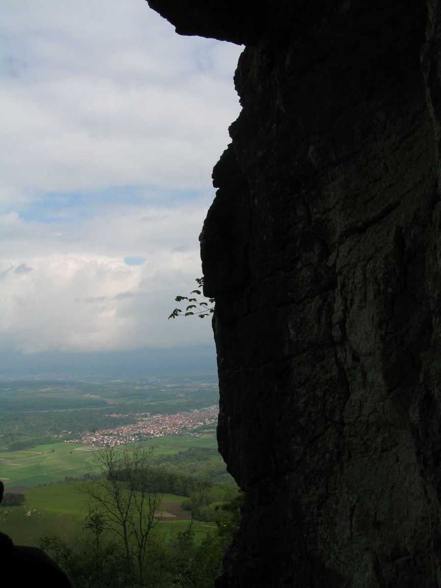 a person with a backpack looks over a cliff