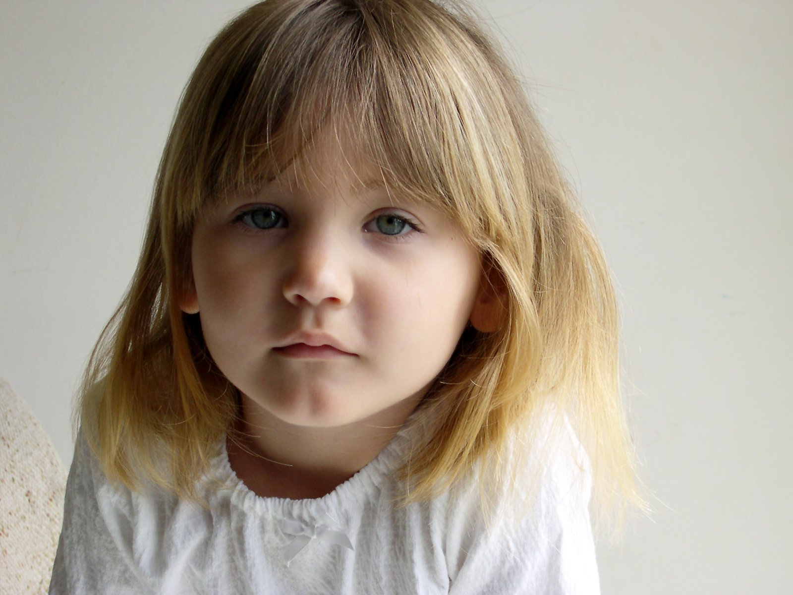 a close up po of a small child with blonde hair