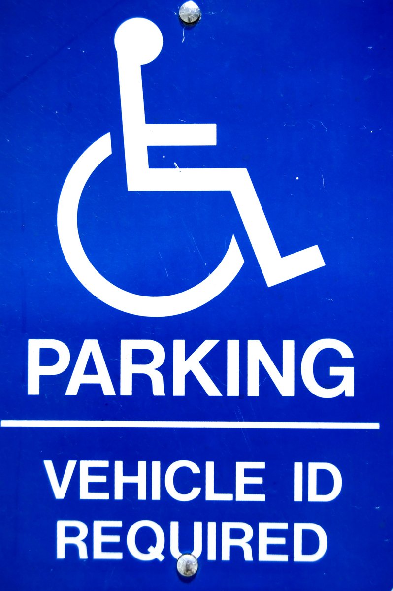 a parking sign that is blue and white