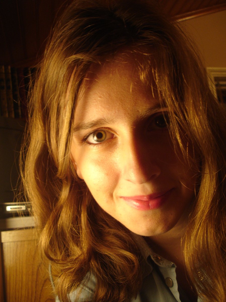 a woman is smiling for the camera with long hair