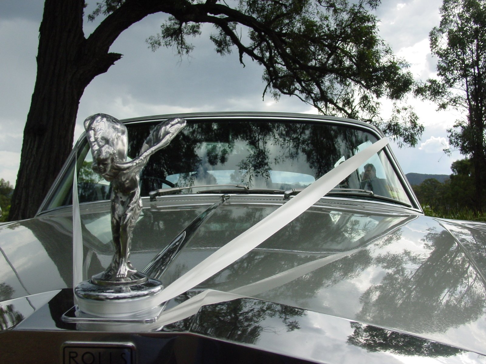 a car with an old fashion figure standing on top of it