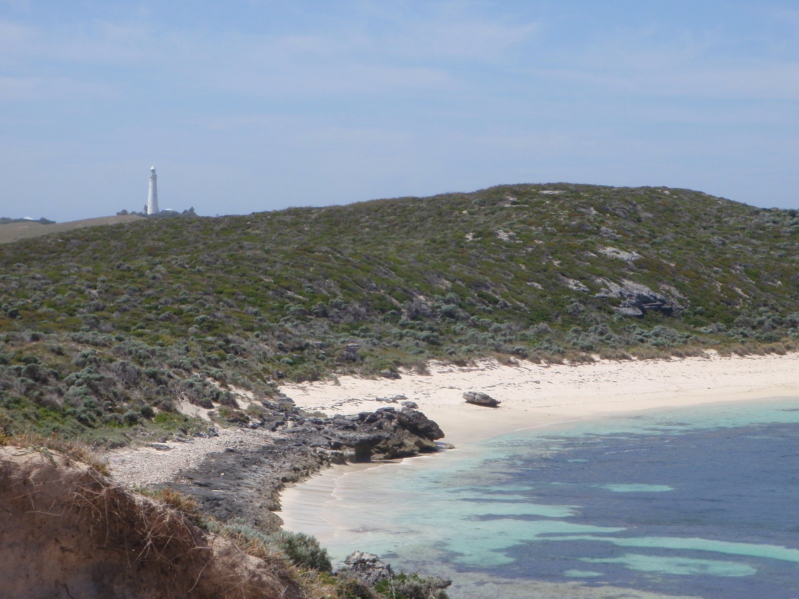 the landscape is beautiful and clear with a small white lighthouse in the distance
