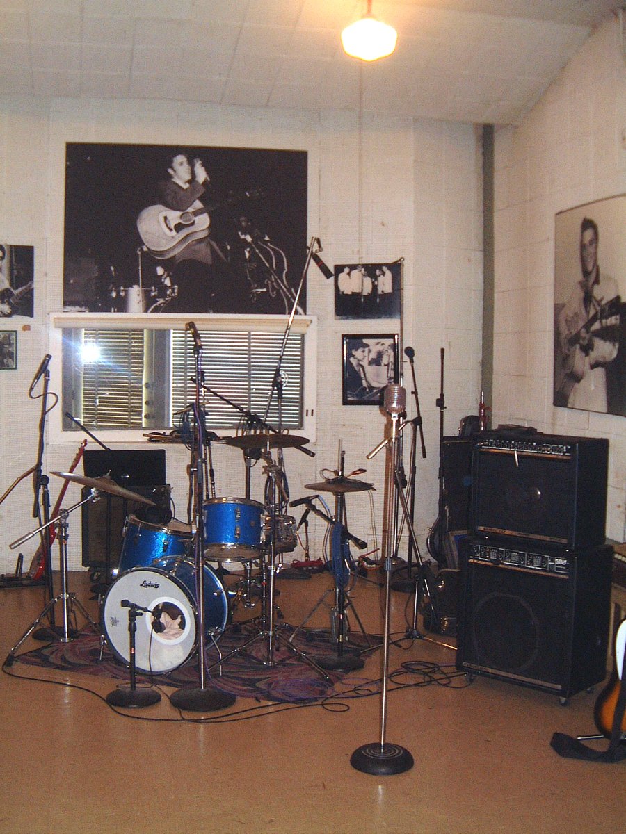 a room filled with musical instruments and guitar amps