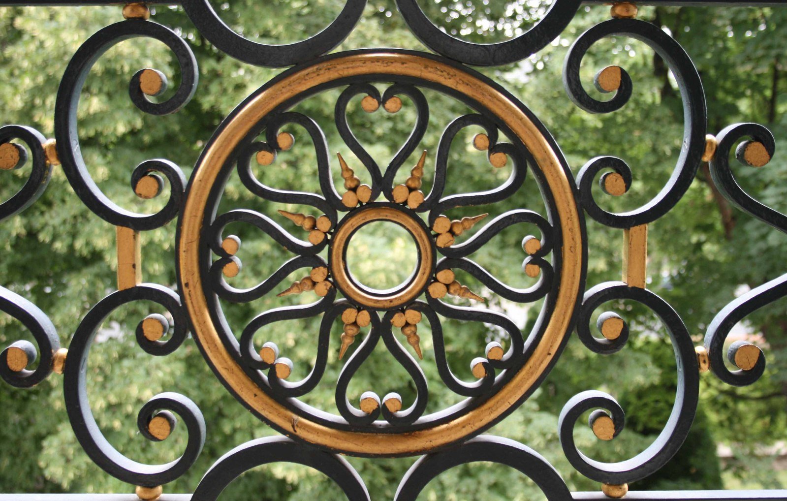 an ornate metal fence with decorative wood circles