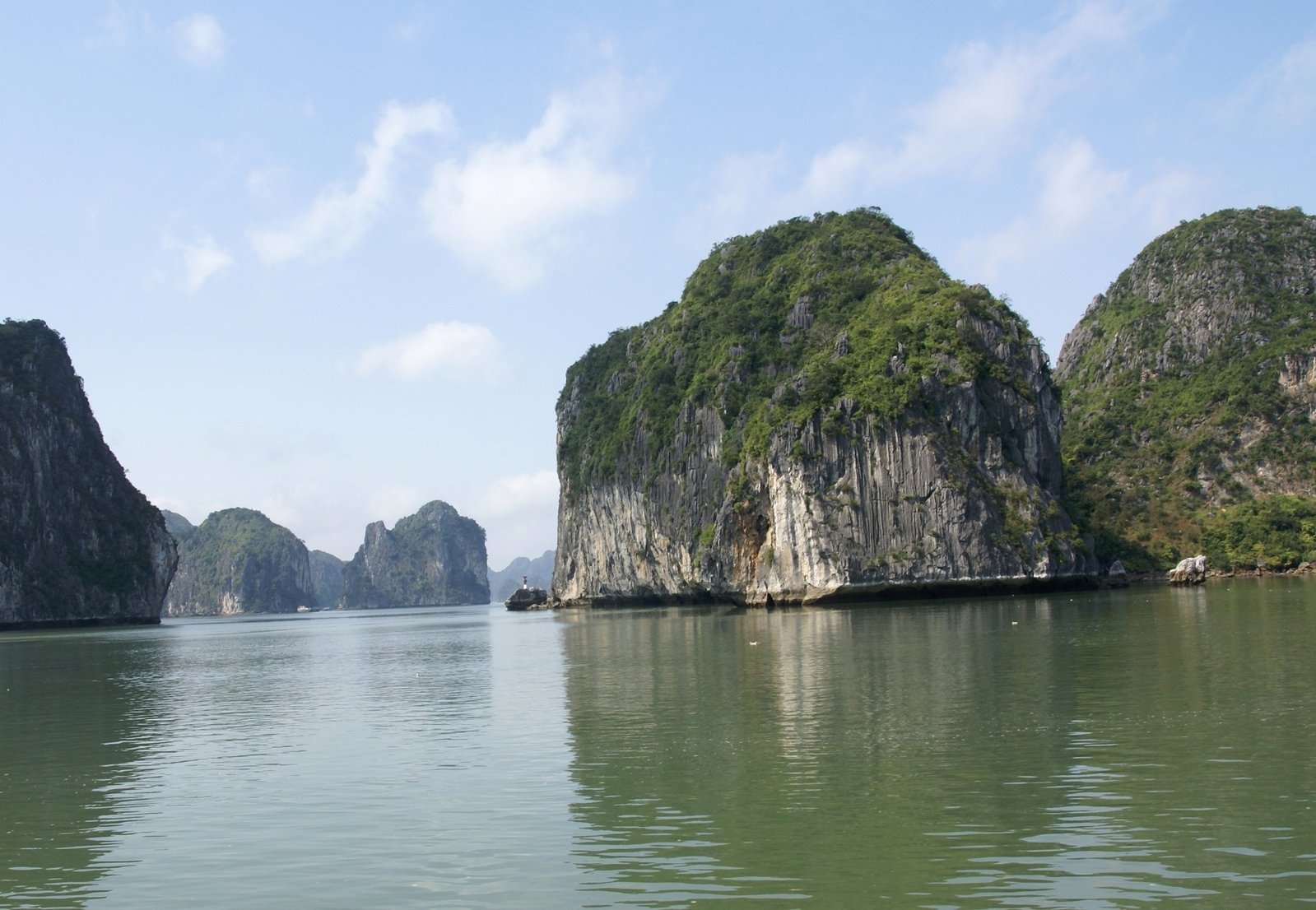 many rocks out on the water surrounded by landforms