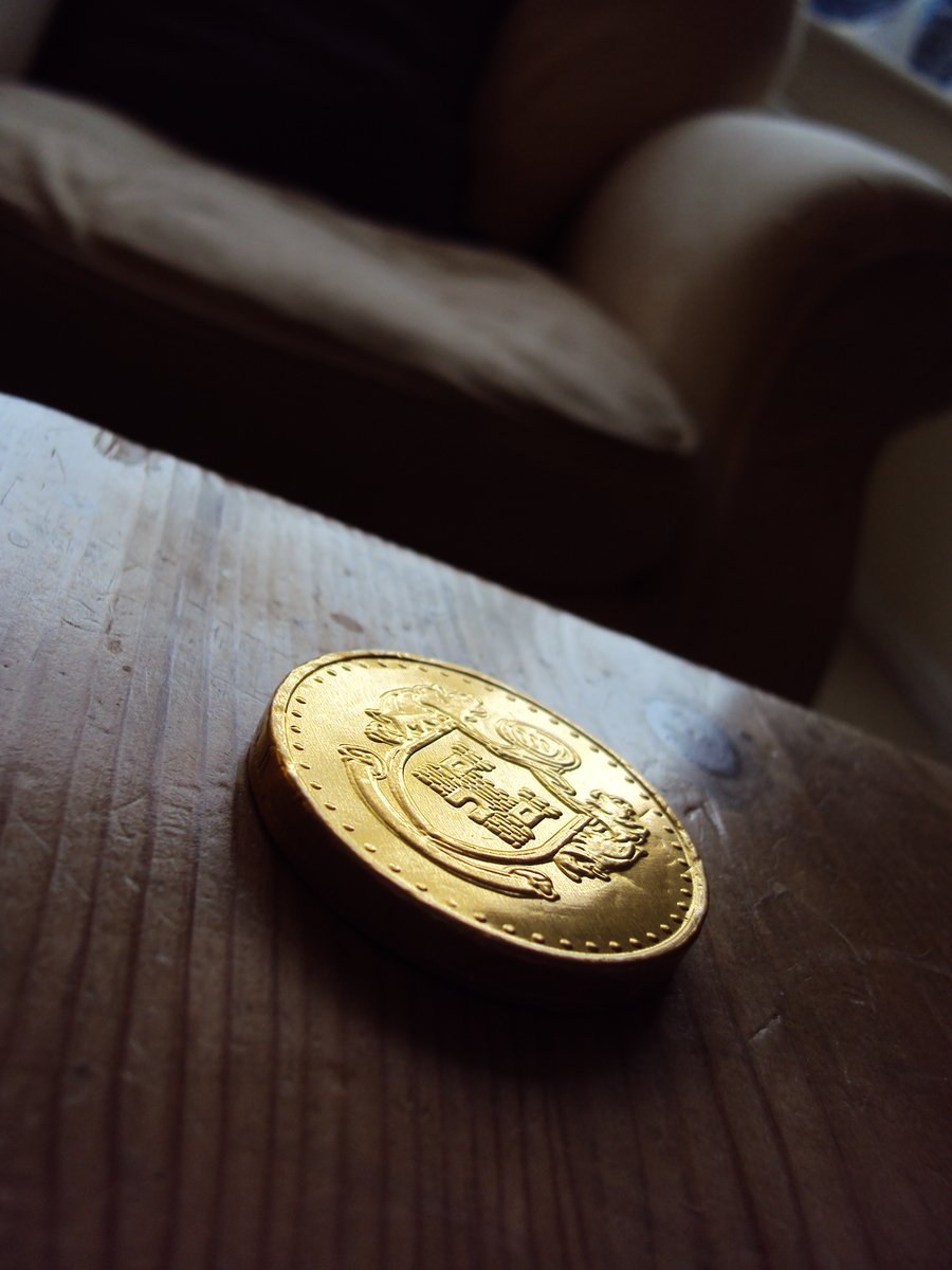 a small gold coin laying on a table