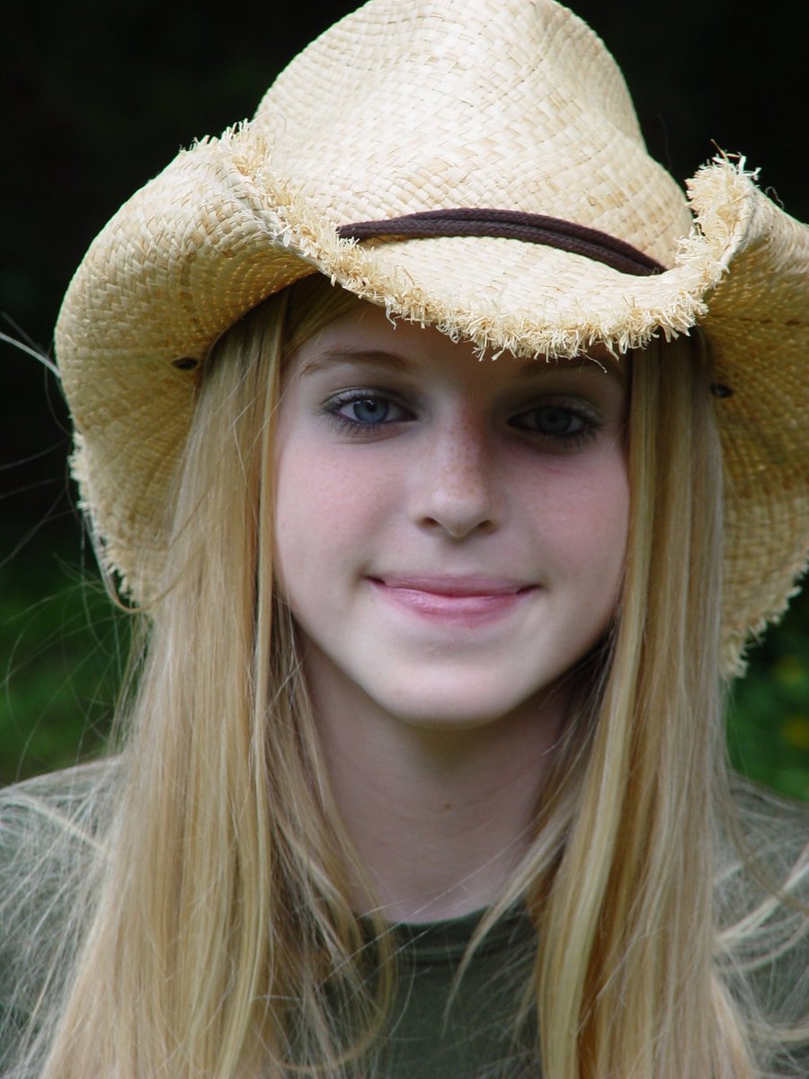 a  with long blonde hair wearing a cowboy hat