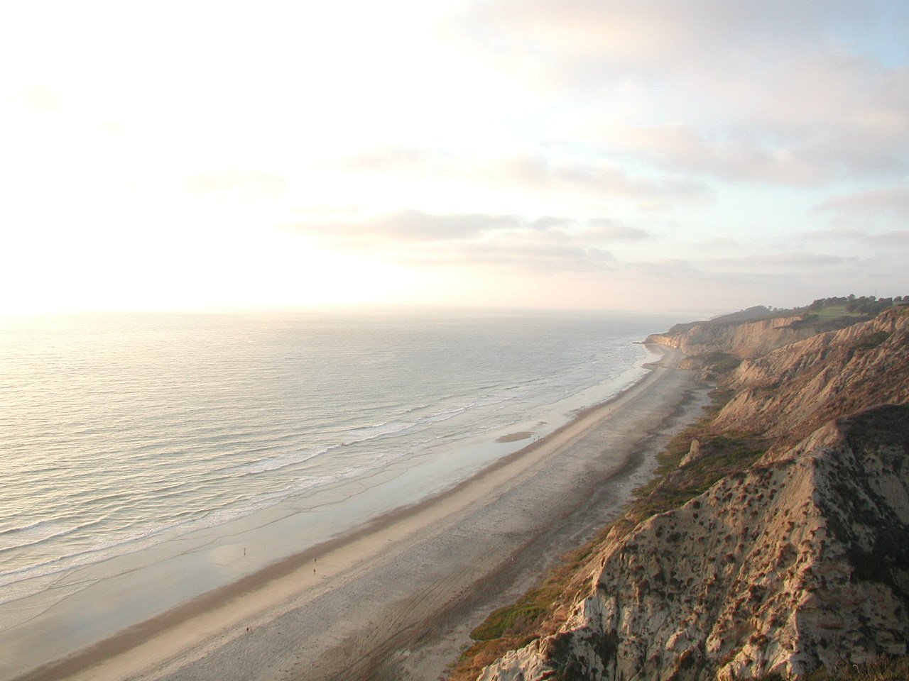 a long stretch of beach on a cliff top near the ocean