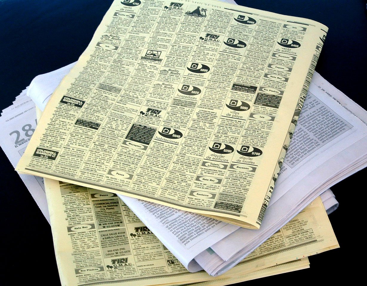 a stack of newspapers sitting on top of each other