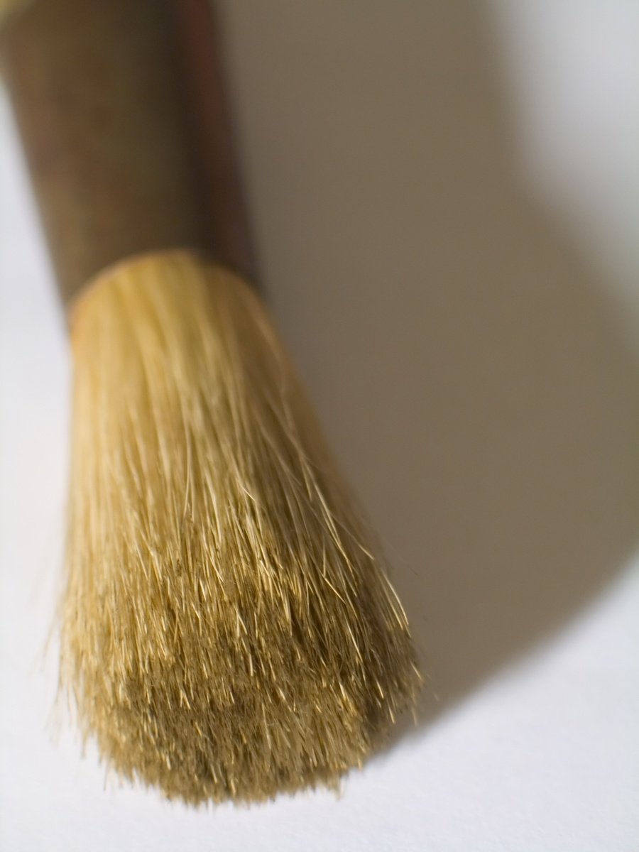 a small brush is being held in the corner
