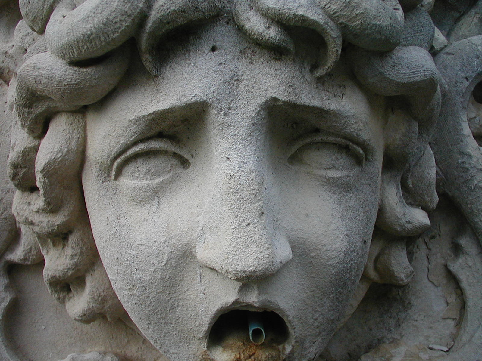 this sculpture has an open mouth and eyes