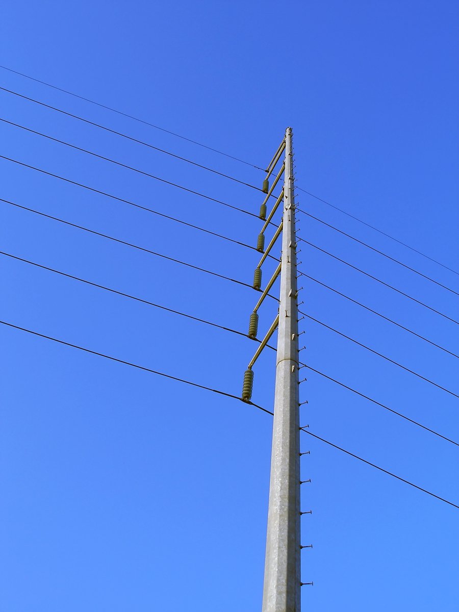 a telephone pole with wires extending into the sky