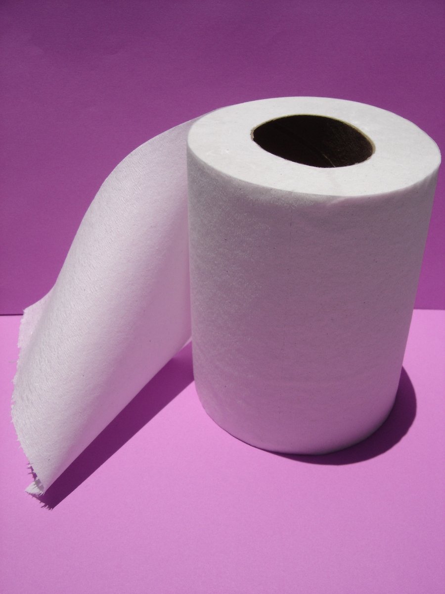 a purple background is shown with a roll of paper