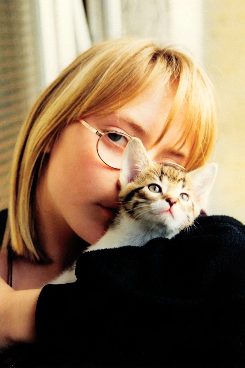 a close up of a person holding a cat