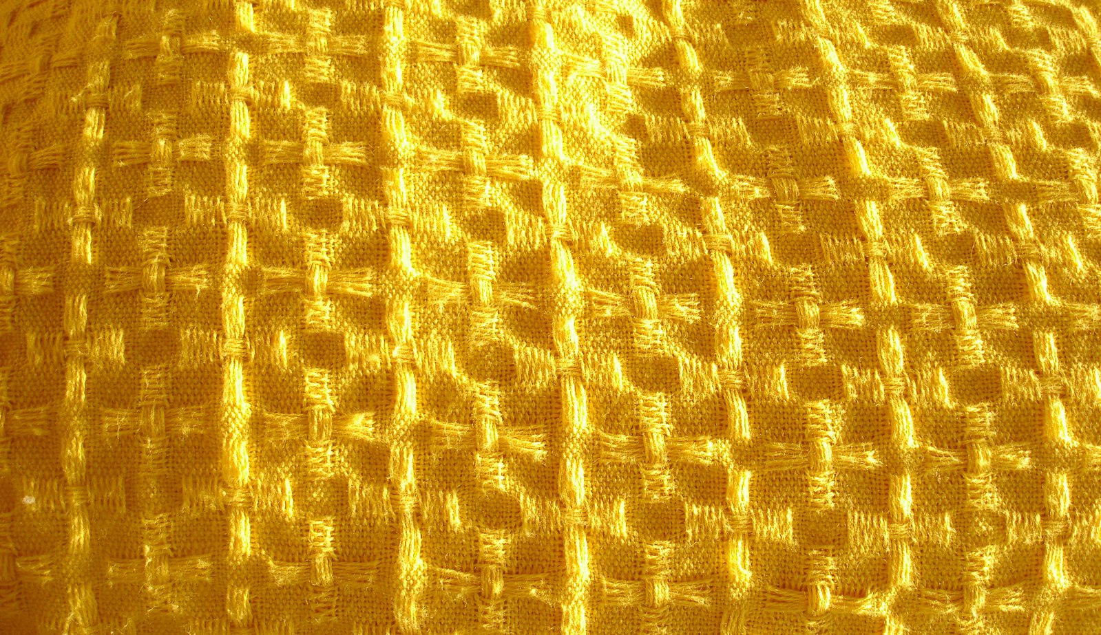 a closeup s of the texture of an antique quilt