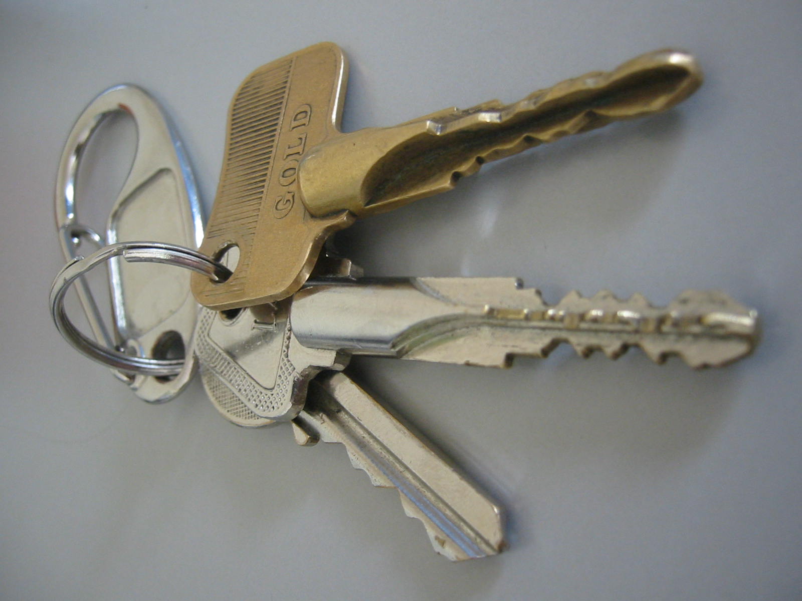 a golden key with five keys that is attached to a silver string