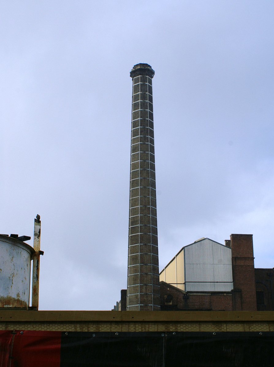 a tall brick tower sitting above buildings