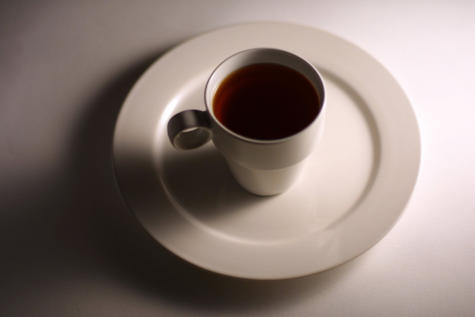 the cup and saucer are sitting on the plate