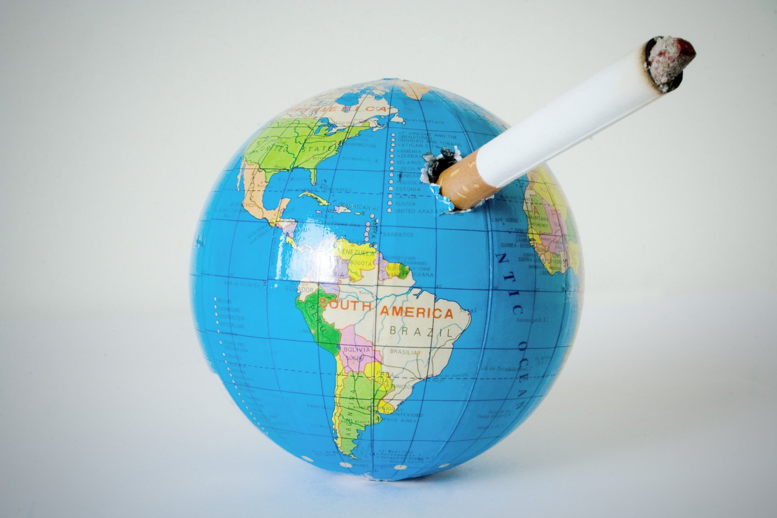 a cigarette in the shape of a globe on a table