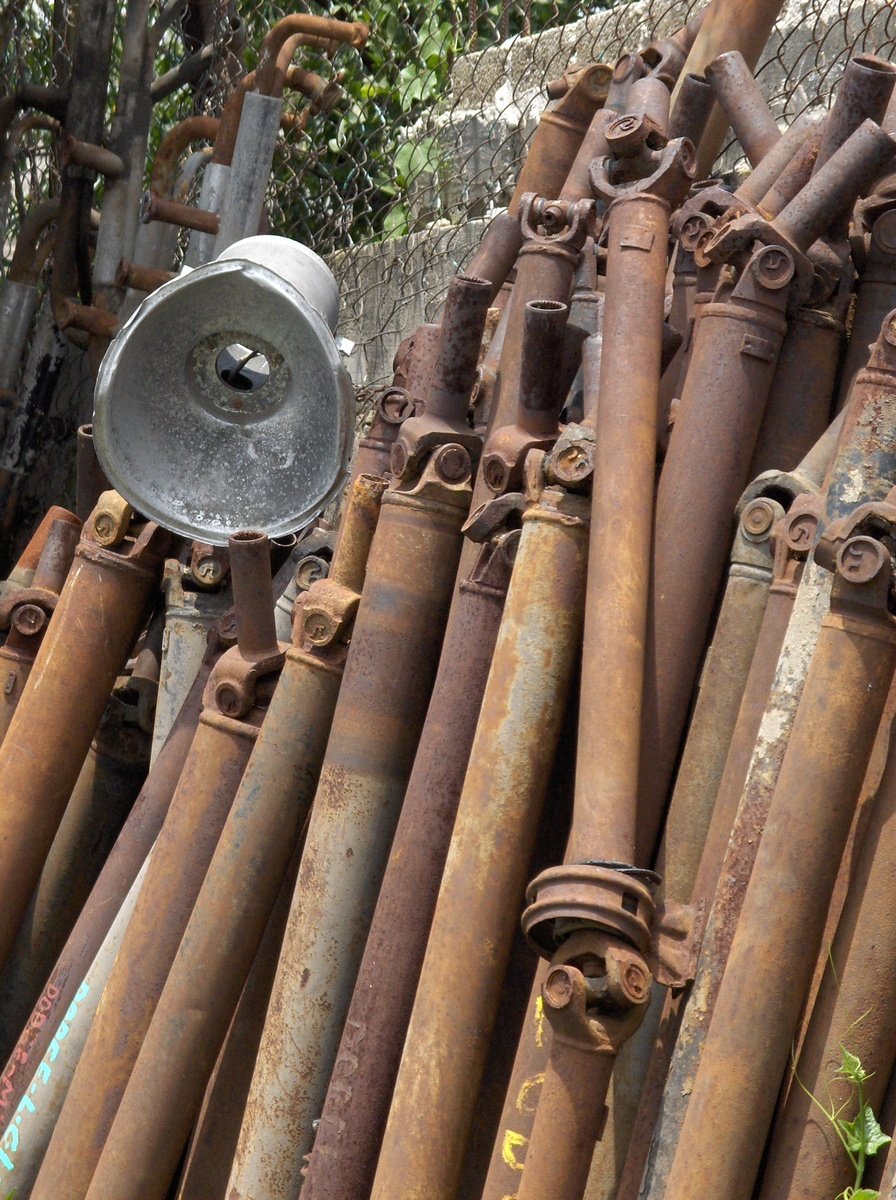 several rusty pipes and a blow dryer in a yard