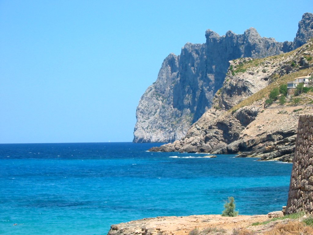 the ocean with a rock structure on top of it