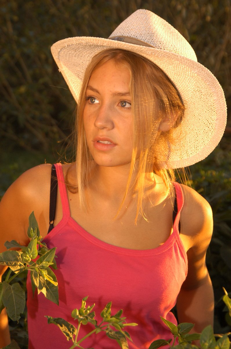 a woman with her hat over her shoulder