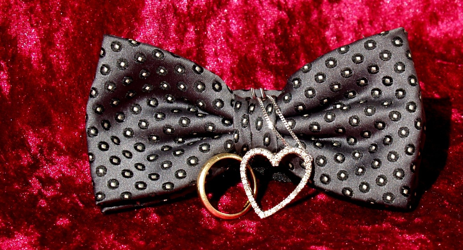 a bow tie with two hearts on it
