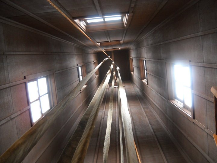 a long, narrow tunnel with beams that pass through it