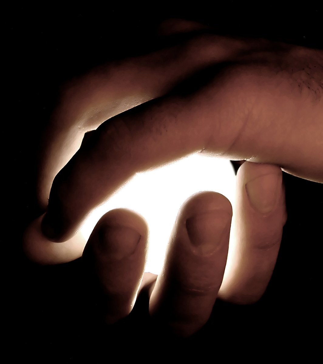 person holding a lit object up to the light