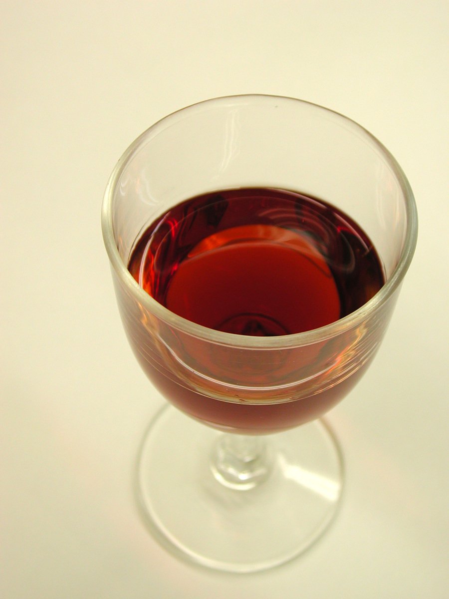 a wine glass filled with liquid that has been placed in it