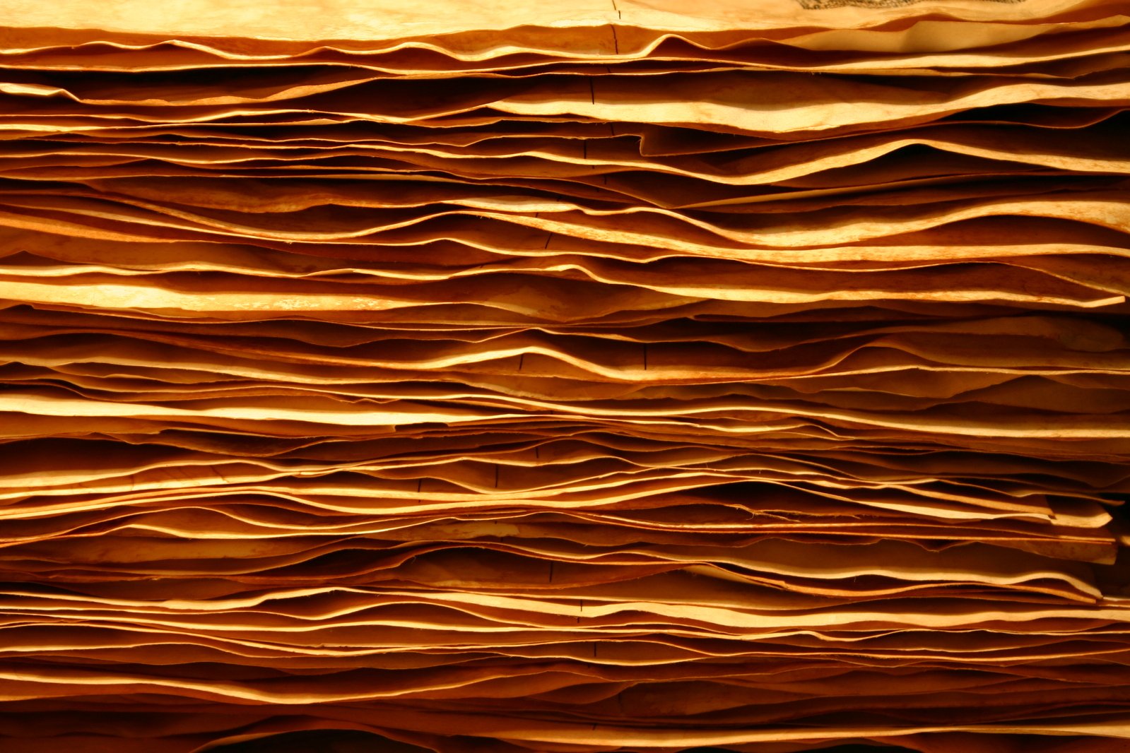 brown wall paper folded to resemble mountains and waves