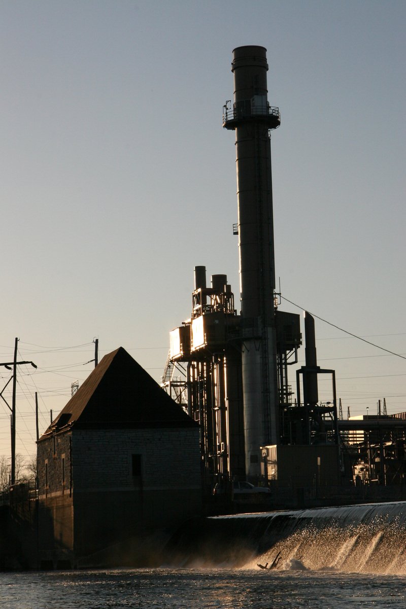 a factory with industrial equipment against a blue sky