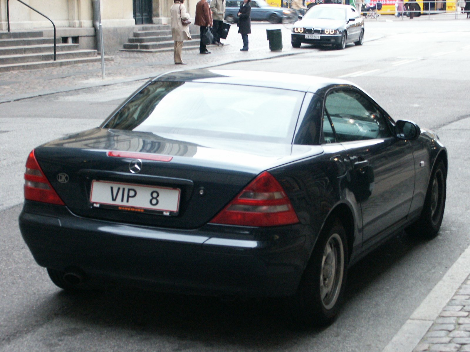 a black car parked on a city street