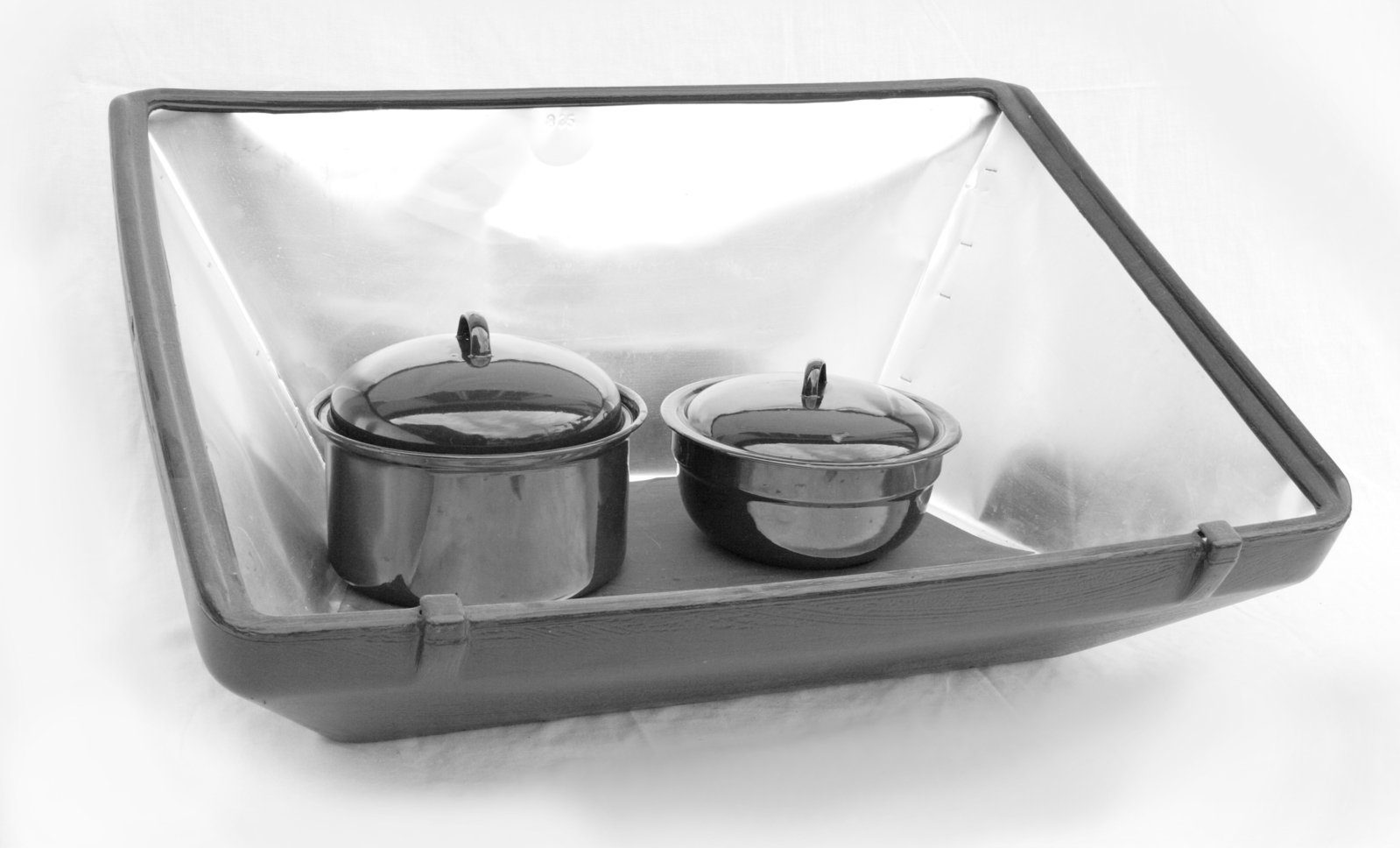 three pots in a metal case with clear back