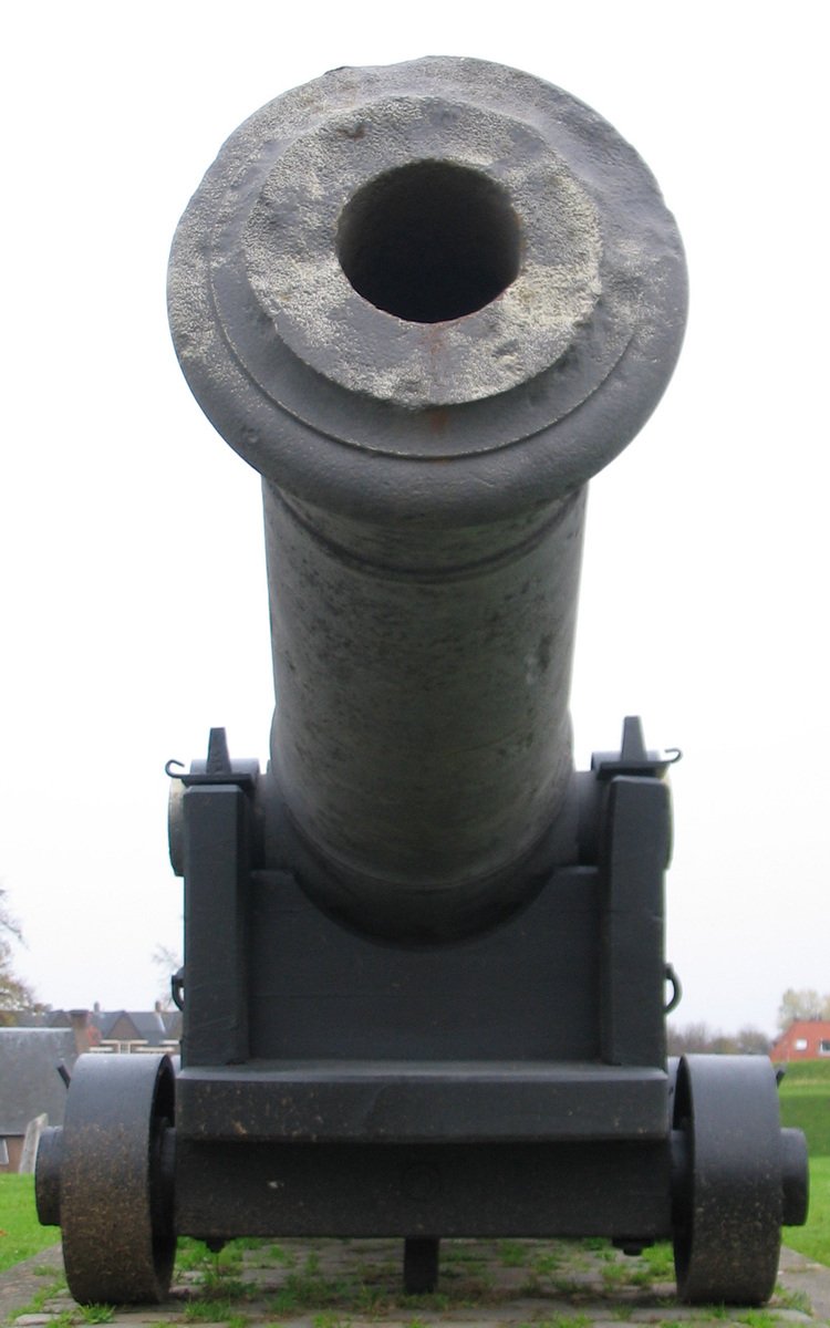 an old fashioned cannon sits on the ground