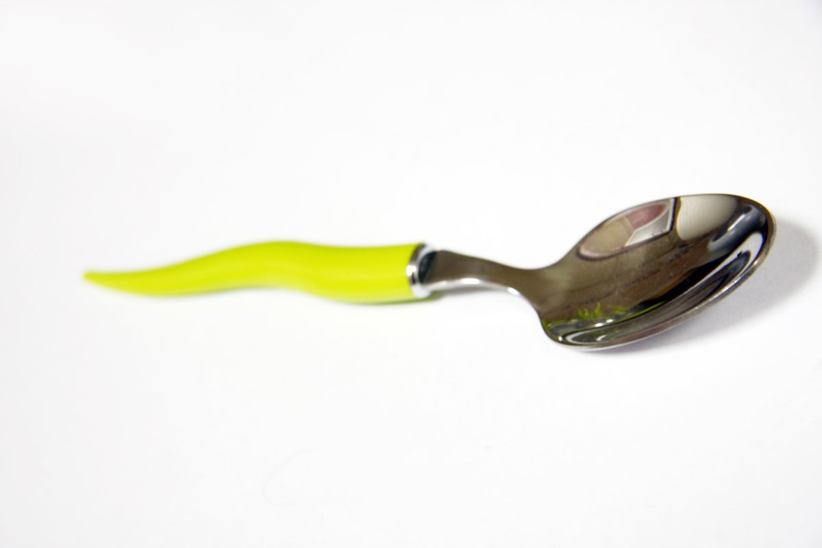 this is a spoon that has a yellow handle