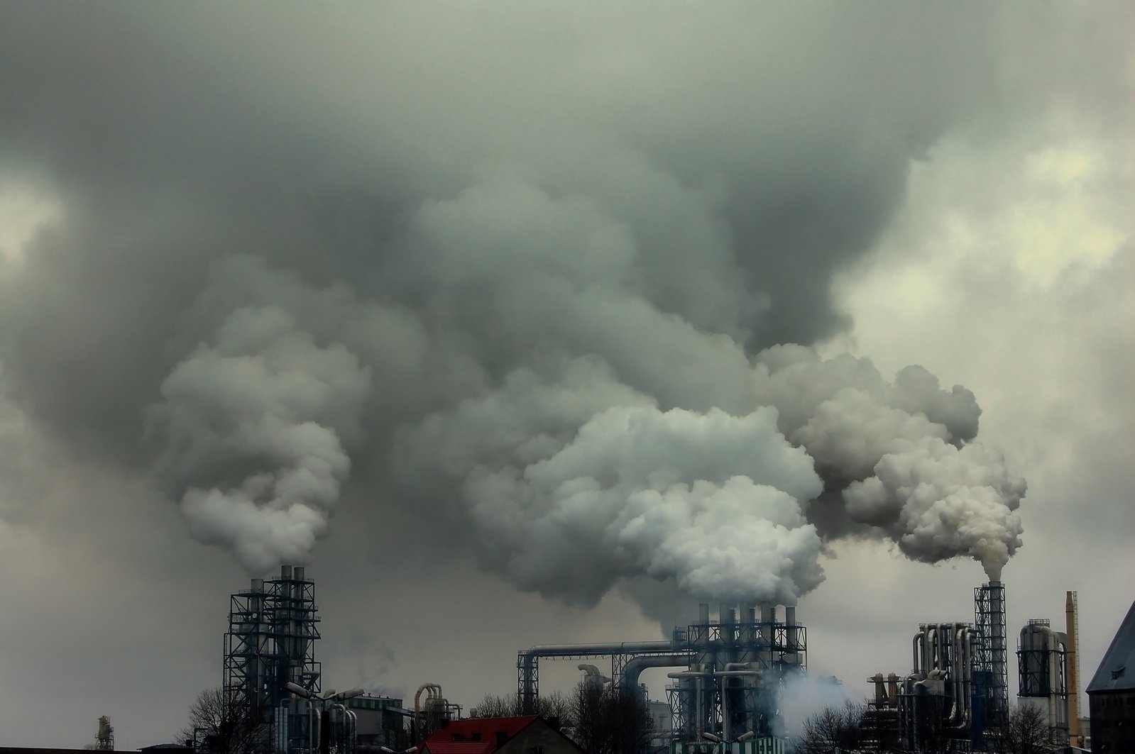 a factory with smoke pouring out of it