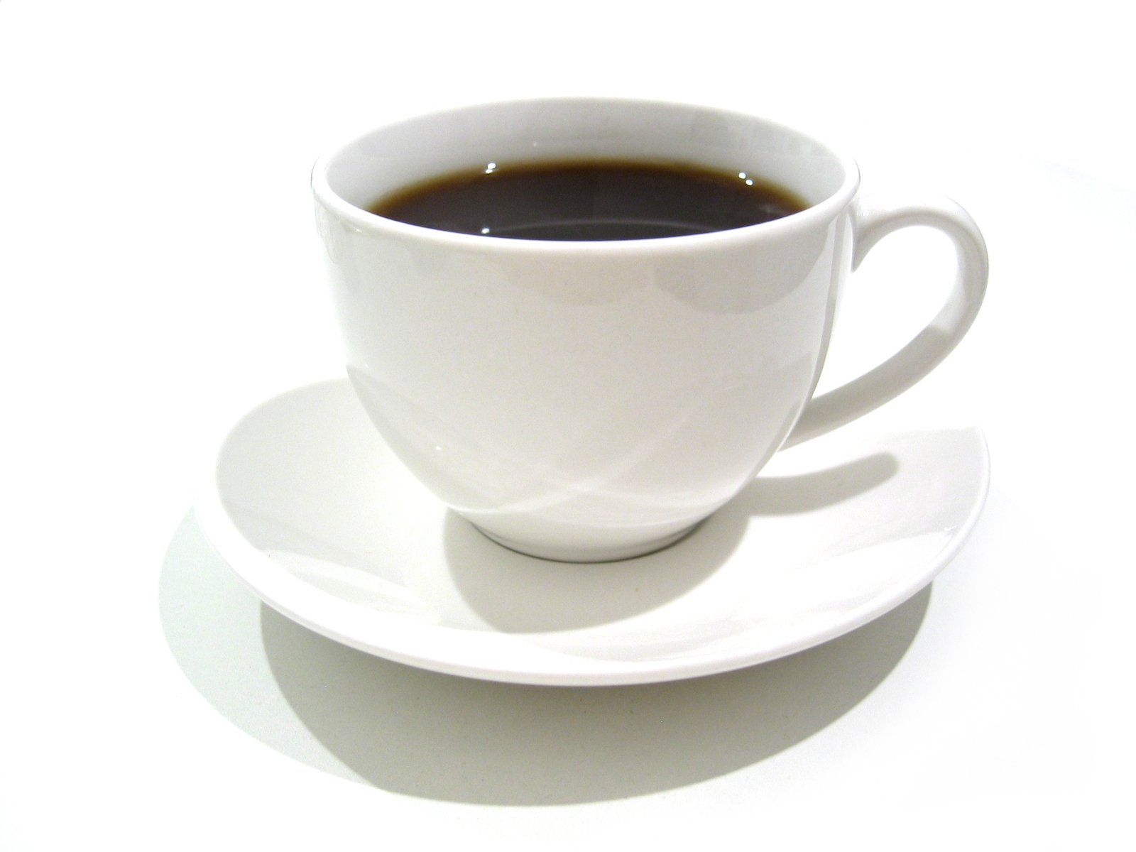 an empty coffee cup and saucer on a white background