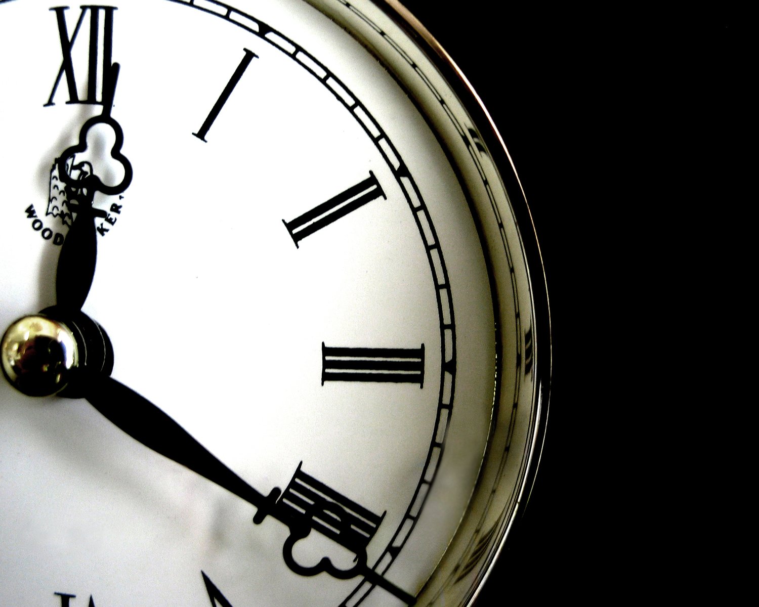 a closeup s of the hands on an analog clock