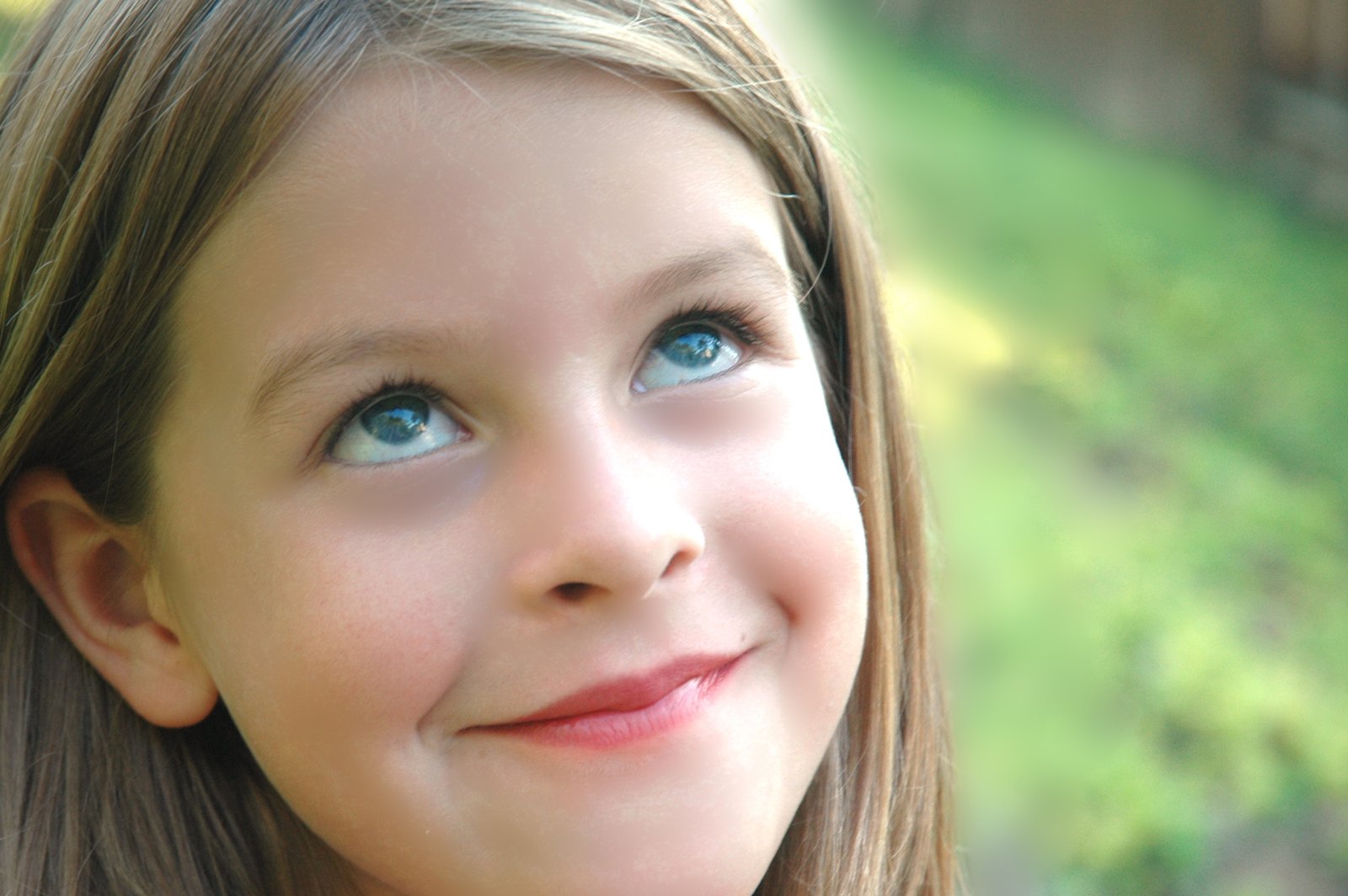 a close - up of a 's face with blue eyes