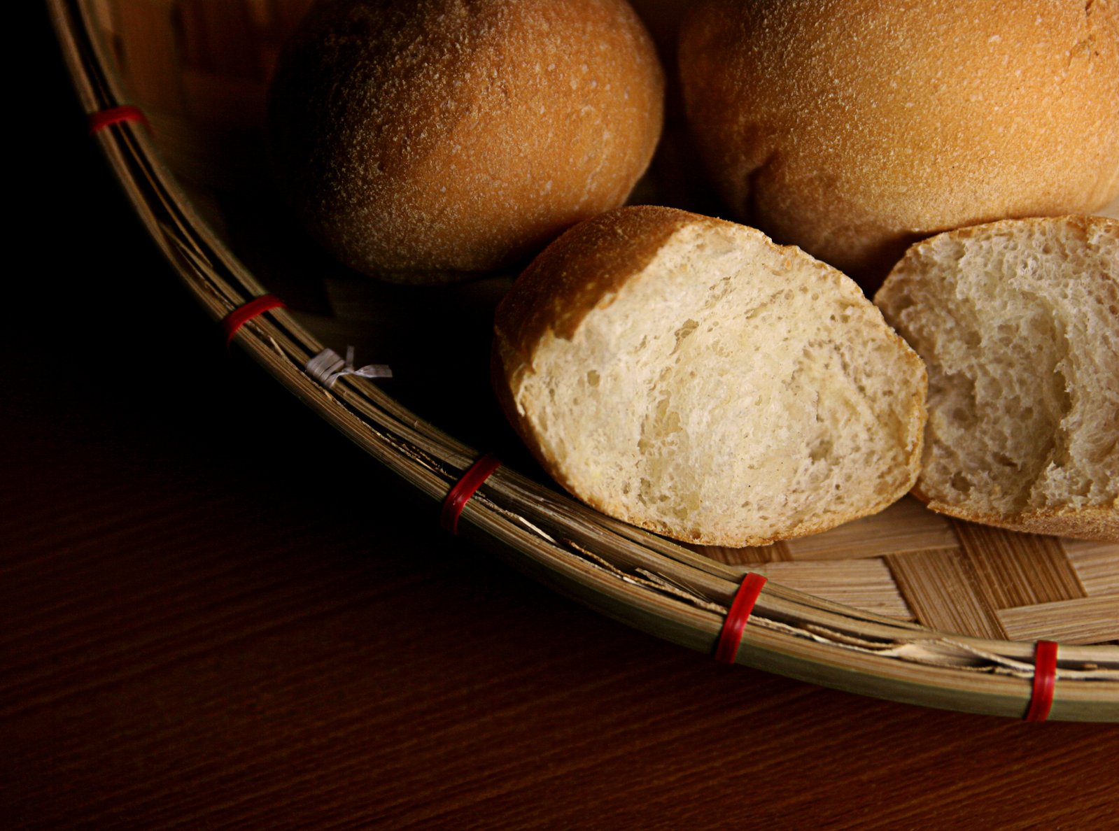 some loaves of bread on a bamboo platter